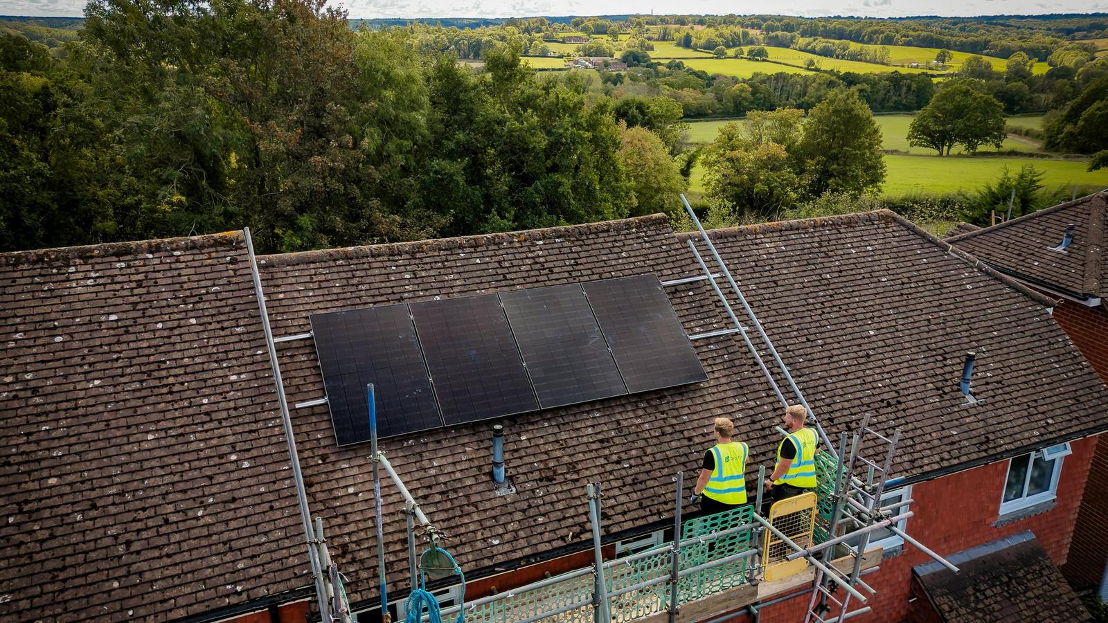 Solar panels being installed on a pitched roof, seen from above