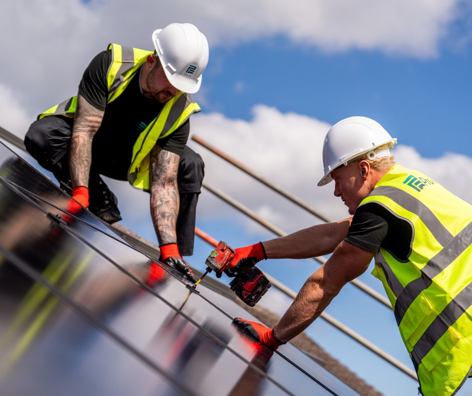 Two Pro-Fit installers fixing a panel to the mounting rails